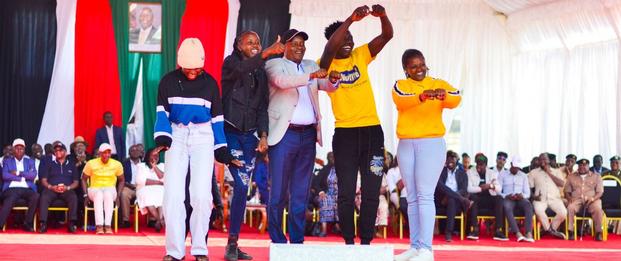 Young people celebrating on stage at a NYOTA Project event.
